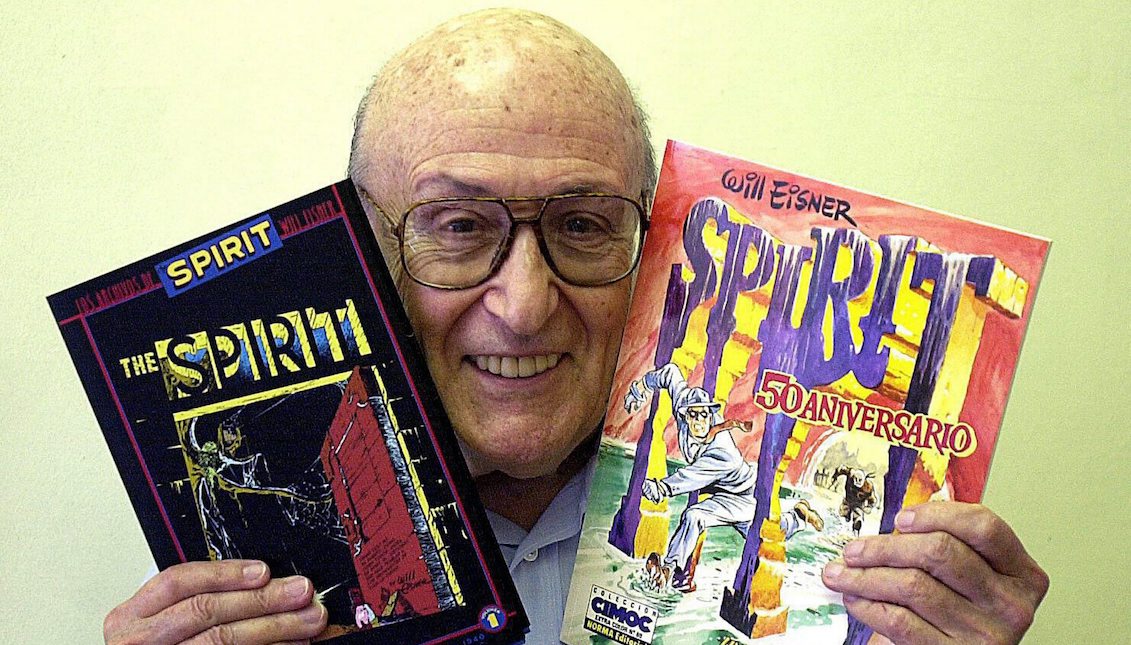 epa000341221 US comic legend Will Eisner poses with two comics of "The Spirit," a masked comic book hero he created in the 1930s, in this file photo taken 09 May 2003 in Barcelona. Eisner died Monday 03 January 2005 at Florida Medical Center in Lauderdale Lakes of complications from a quadruple bypass heart surgery last month. EPA/Alberto Estevez