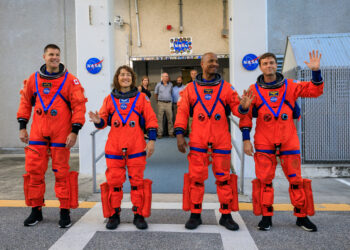 Artemis II crew members (from left) CSA (Canadian Space Agency) astronaut Jeremy Hansen, and NASA astronauts Christina Koch, Victor Glover, and Reid Wiseman walk out of Astronaut Crew Quarters inside the Neil Armstrong Operations and Checkout Building to the Artemis crew transportation vehicles prior to traveling to Launch Pad 39B as part of an integrated ground systems test at Kennedy Space Center in Florida on Wednesday, Sept. 20, to test the crew timeline for launch day.